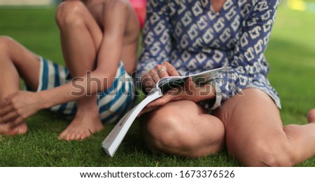 Similar – grandma reading a book to a child