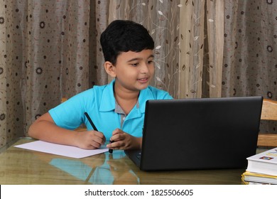 Young boy learning through laptop. E- learning concept - Shutterstock ID 1825506605