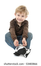 Young Boy Learning To Tie His Shoes