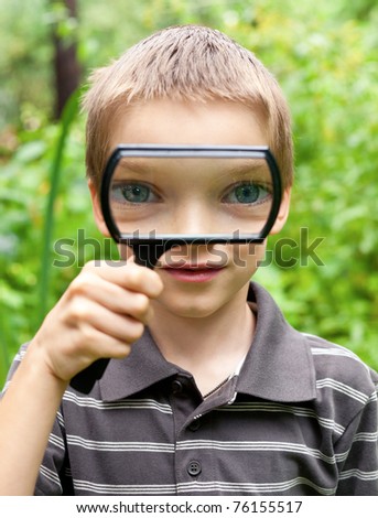 Similar – Child with reading magnifier