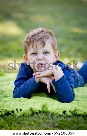 Similar – Cute little boy seated on the wall of a castle