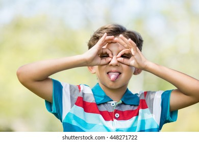 Young boy making a funny faces in park