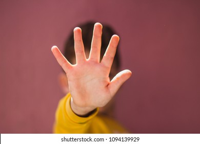 Young boy making stop gesture with his hand