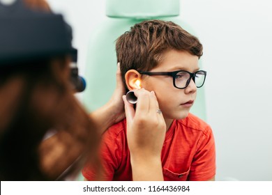 Young boy at medical examination or checkup in otolaryngologist's office