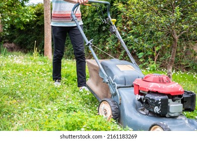 A Young Boy Mowing Lawn