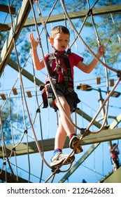 Young Boy Navigating Treetop Ropes Course