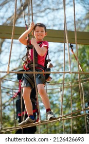 Young Boy Navigating Treetop Ropes Course