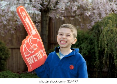 Young Boy With A Number 1 Foam Hand