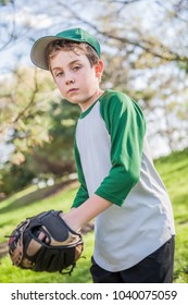 Young Boy Playing Baseball In His Backyard