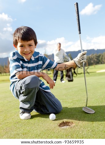 Young boy playing golf at the club