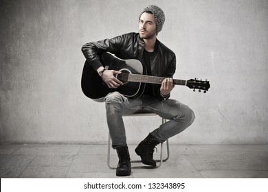 young boy playing guitar - Powered by Shutterstock