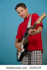 Young boy playing his guitar