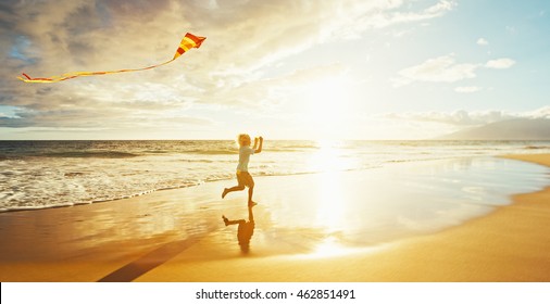 Young Boy Playing With Kite On The Beach