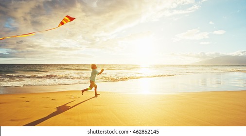 Young Boy Playing With Kite On The Beach