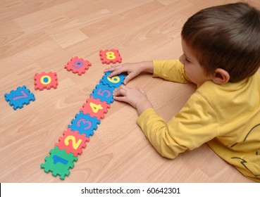 young boy playing with numbers