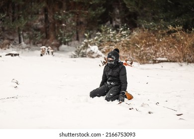 Young Boy Playing In Snowy Winter Wonderland Wearing Snowsuit