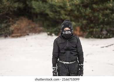 Young Boy Playing In Snowy Winter Wonderland Wearing Snow Suit