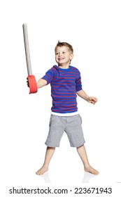 Young boy playing with toy sword, studio
