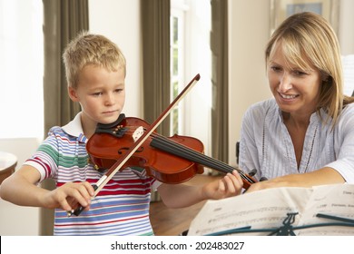 Young Boy Playing Violin In Music Lesson