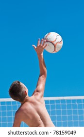 Young Boy Playing Volleyball On Beach