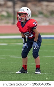 Young boy playing in a youth tackle football game