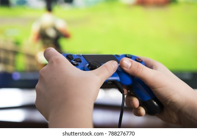 A young boy plays on a gaming console
