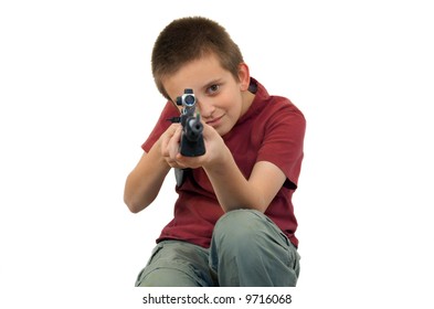 young boy pointing gun at camera, focus on boys face, isolated
