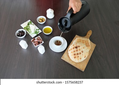 Young Boy Pouring Tea To Drink With His Healthy Breakfast