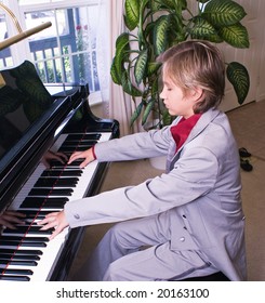 A Young Boy Practices His Piece For A Recital