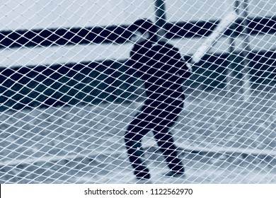 Young boy is practicing cricket in the nets isolated unique background photo