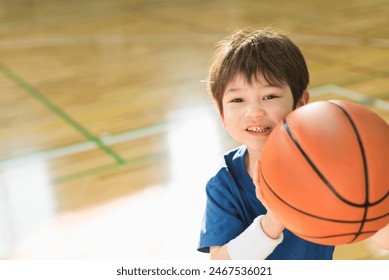 A young boy practising basketball. - Powered by Shutterstock