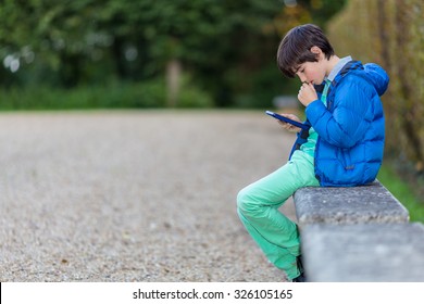Young boy reading an ebook.