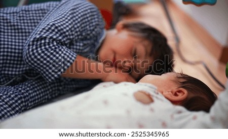 Relaxed mother and sons playing over the bed