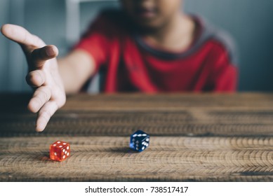 Young Boy Rolling / Throwing A Dice