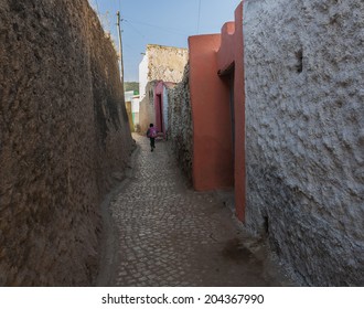 Young boy running as he is late for school in narrow alleyway of ancient city of Jugol. Harar. Ethiopia. - Powered by Shutterstock