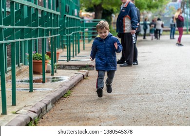 Young Boy Running Towards The Camera