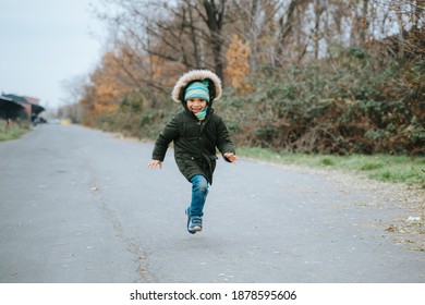 Young Boy Running Towards Camera