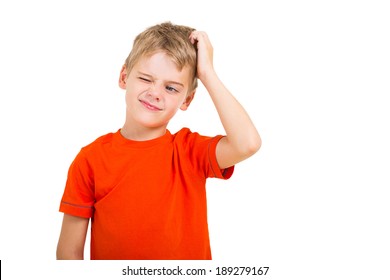 young boy scratching his head isolated on white