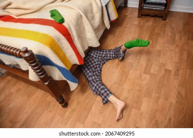 Young Boy Searching For His Lost Sock Under The Bed