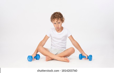 Young Boy Sitting With Hand Weights Making Tough Guy Expression Isolated On White Background