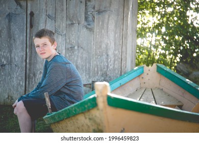 Young boy sitting on a boat.