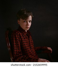 Young boy sitting on the chair portrait