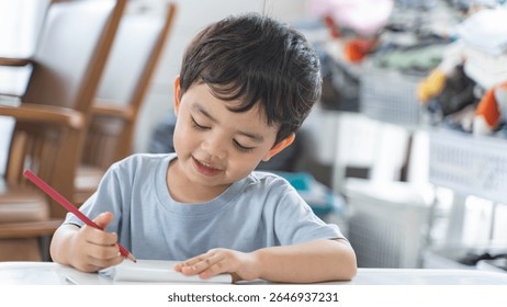 A young boy smiling while doing his homework at home, showing focus and enjoyment during a learning activity. Perfect representation of joyful early education.