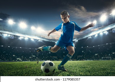 Young Boy With Soccer Ball Doing Flying Kick At Stadium. Football Soccer Players In Motion On Green Grass Background. Fit Jumping Boy In Action, Jump, Movement At Game. Collage