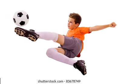 Young Boy With Soccer Ball Doing Flying Kick, Isolated On White