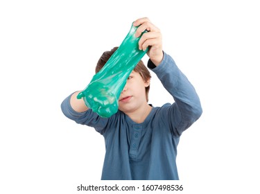 Young boy squeezing a slime. Isolated on white background.