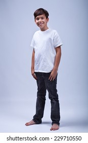 Young Boy Standing Barefoot Wearing Casual Clothes