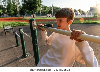 A young boy is standing with a baseball bat held casually over his shoulder. He appears confident and ready to play. - Powered by Shutterstock