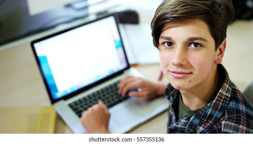 Young Boy Student, Studying Computer And Is Happy To Learn New Things