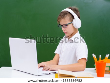 Young boy student, studying computer
